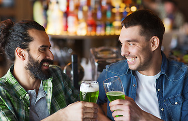 Image showing male friends drinking green beer at bar or pub