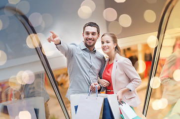 Image showing happy young couple with shopping bags in mall