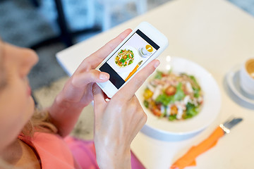 Image showing woman with smartphone photographing food at cafe