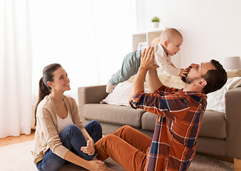 Image showing happy mother and father playing with baby at home