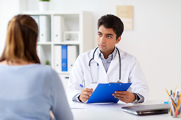 Image showing doctor with clipboard and patient at hospital