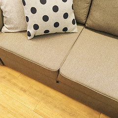 Image showing Polka dot cushion decorating a textile sofa