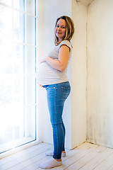 Image showing Beautiful pregnant woman standing near window