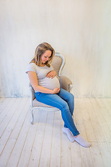 Image showing Young pregnant woman sitting