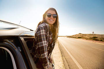 Image showing happy girl looking out the car window