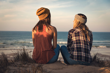 Image showing Girls sitting on the beach