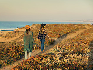 Image showing Girs walking ove the coastline