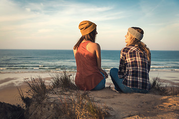 Image showing Girls sitting on the beach