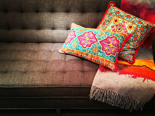 Image showing Textile sofa decorated with bright ornate cushions