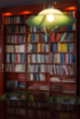 Image showing Defocused image of bookcase and green lamp