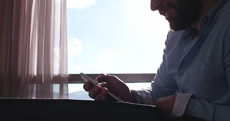 Image showing Business Man Talking On Cell Phone At Home