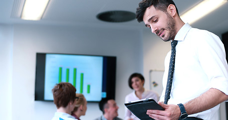 Image showing Businessman using tablet in modern office