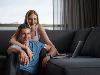 Image showing Attractive Couple Using A Laptop on couch