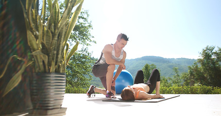 Image showing Couple Doing Stretching Exercises Together in front of luxury vi