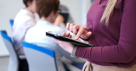 Image showing Pretty Businesswoman Using Tablet In Office Building during conf