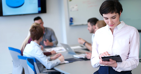 Image showing Portrait of  smiling casual businesswoman using tablet  with cow