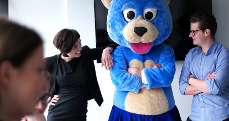 Image showing boss dresed as bear having fun with business people in trendy of