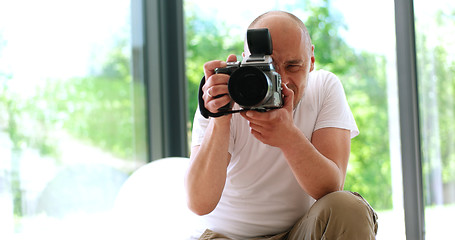 Image showing Photographer takes pictures with DSLR camera