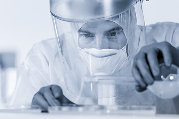 Image showing Life scientist researching in bio hazard laboratory. High degree of protection work.