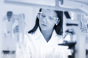 Image showing Female chemist working in scientific laboratory.