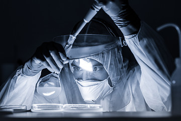 Image showing Life scientist researching in bio hazard laboratory. High degree of protection work.