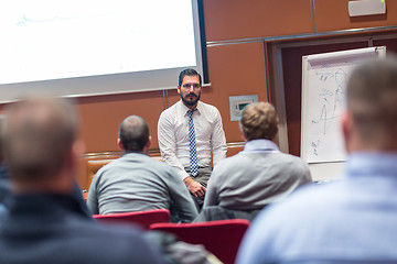 Image showing Skiled Businessman Presenting a Project to His Work Team at Informal Company Meeting.