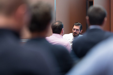 Image showing Skiled Businessman Presenting a Project to His Work Team at Informal Company Meeting.