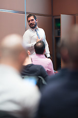 Image showing Skiled Businessman Presenting a Project to His Work Team at Informal Company Meeting.