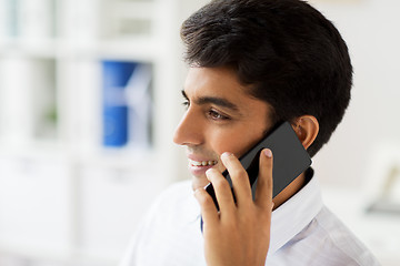 Image showing businessman calling on smartphone at office