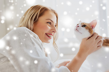 Image showing happy young woman with cat in bed at home