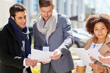 Image showing international business team with papers outdoors