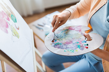 Image showing artist with palette knife painting at art studio