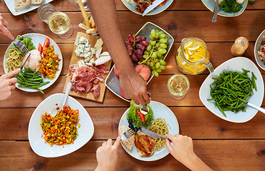 Image showing group of people eating at table with food