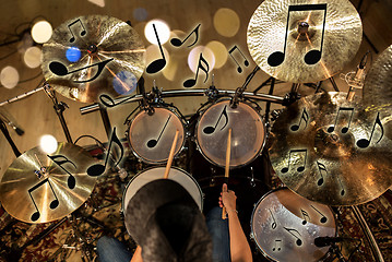 Image showing male musician playing drum kit at concert