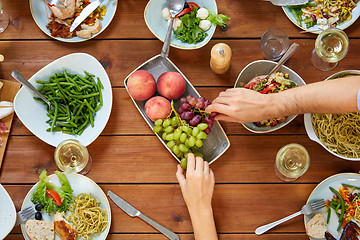 Image showing group of people eating at table with food