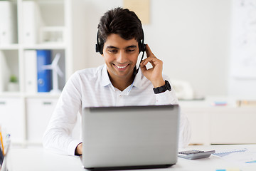 Image showing businessman with headset and laptop at office