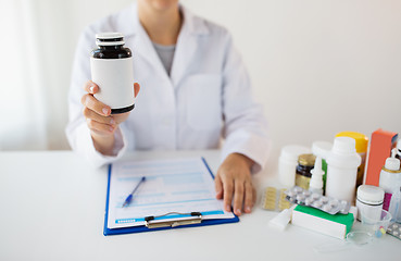 Image showing close up of doctor with medicines and clipboard