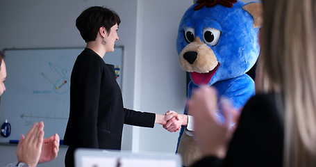 Image showing boss dresed as bear having fun with business people in trendy of