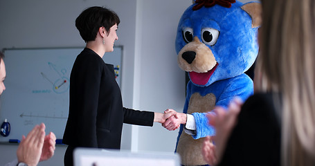 Image showing boss dresed as bear having fun with business people in trendy of