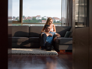 Image showing Attractive Couple Using A Laptop on couch