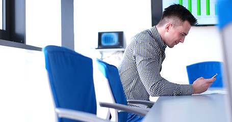 Image showing Senior businessman  using cell phone at  stratup office