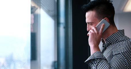 Image showing Business Man Talking On Cell Phone, Looking Out Office Window