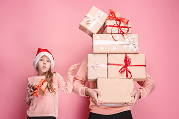 Image showing Portrait of a surprised little girl with her father holding a Christmas present