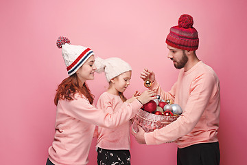 Image showing Father and mother give gifts to little daughter at studio