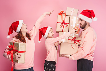 Image showing Father and mother give gifts to little daughter at studio