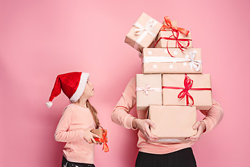 Image showing Portrait of a surprised little girl with her father holding a Christmas present