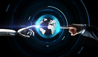 Image showing human and robot hand with virtual earth hologram