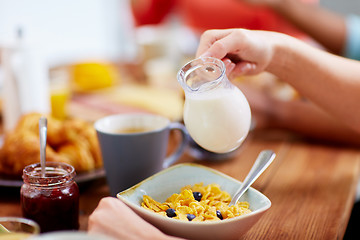 Image showing hands of woman eating cereals for breakfast