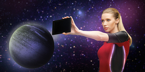 Image showing futuristic woman with tablet pc over space