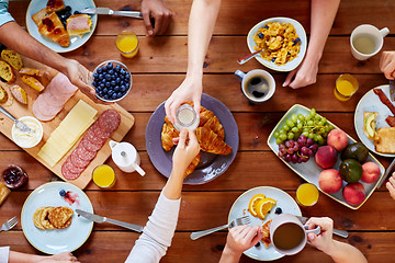 Image showing people having breakfast at table with food